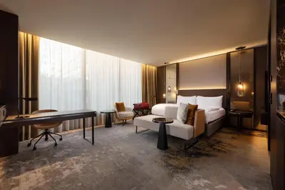 a hotel room with a bed and a desk at InterContinental - Ljubljana by IHG in Ljubljana