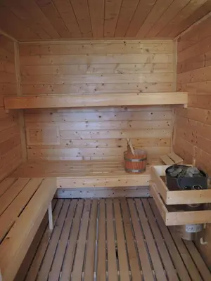 a wooden sauna with a bucket in it at Razborca in Mislinja