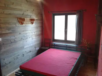 a room with a bed in a room with a window at Razborca in Mislinja