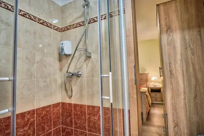 a shower with a glass door in a bathroom at Hiša Linhart, Hotel & Restaurant in Radovljica