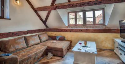 a living room with a couch and a table at Hiša Linhart, Hotel & Restaurant in Radovljica