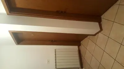 a bathroom with a ceiling and a door in a room at Gostišče Hedvika in Kal-Koritnica