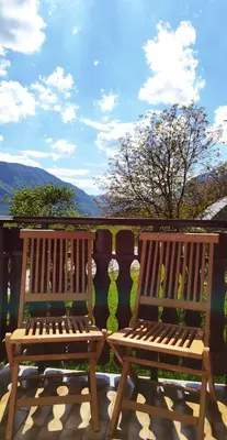 two wooden benches sitting on top of a deck at Gostišče Hedvika in Kal-Koritnica
