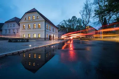 a city street at night with a building and a bus at Hostel Bearlog Kočevje in Kočevje