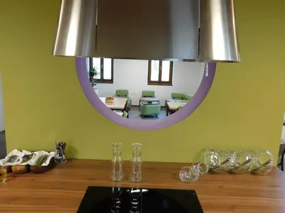 a dining room with a mirror and a table at Hostel Bearlog Kočevje in Kočevje