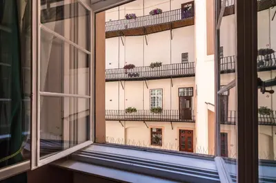 an open window with a view of a building at Barbo Palace Apartments and Rooms in Ljubljana
