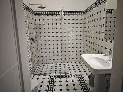 a black and white bathroom with a sink and a toilet at Barbo Palace Apartments and Rooms in Ljubljana