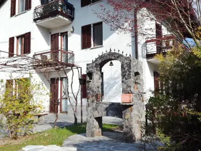 a building with a stone fireplace in front of it at Pri Mlinarju in Tolmin