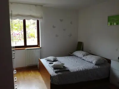 a bedroom with a bed and a window at Pri Mlinarju in Tolmin