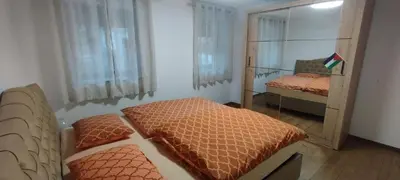 a small bedroom with two beds and a mirror at Apartments Ten Sen in Kobarid
