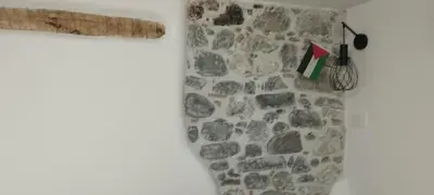 a room with a stone wall with a window at Apartments Ten Sen in Kobarid