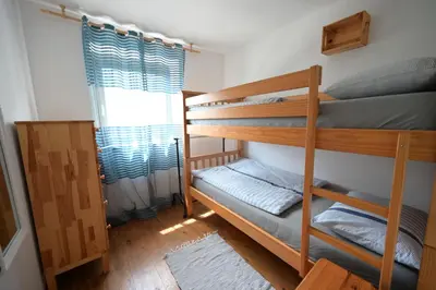 two bunk beds in a room with a window at Apartments Ten Sen in Kobarid