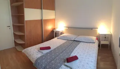 a bedroom with a bed with two red pillows at Apartment Nova Gorica - Nočitve Falco in Nova Gorica