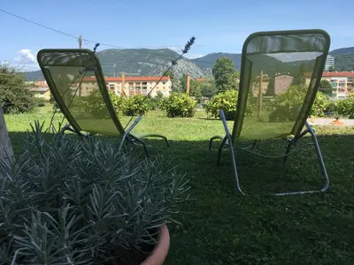 two chairs sitting in the grass in a yard at Apartment Nova Gorica - Nočitve Falco in Nova Gorica