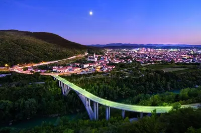 a bridge over a river with a city in the background at Apartment Nova Gorica - Nočitve Falco in Nova Gorica