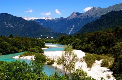 a view of a river with mountains in the background at Apartment Nova Gorica - Nočitve Falco in Nova Gorica