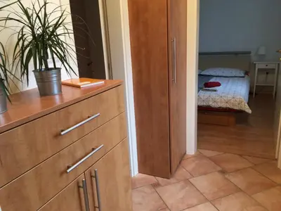 a room with a dresser and a bedroom with a bed at Apartment Nova Gorica - Nočitve Falco in Nova Gorica