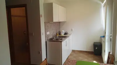 a small kitchen with white cabinets and a sink at Apartments Bernarda in Bled