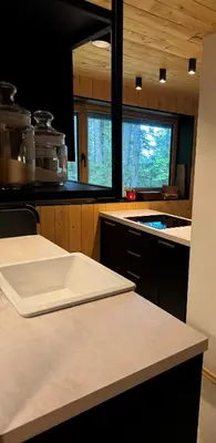 a kitchen with a white chopping board on a counter at Cosy Lodge Pokljuka in Goreljek
