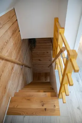a staircase in a house with wood flooring at ALPEART BOHINJ HOLIDAY units in Bohinj