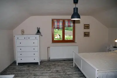 a bedroom with a bed and a dresser and a window at Apartma Obrh in Smarjeske Toplice