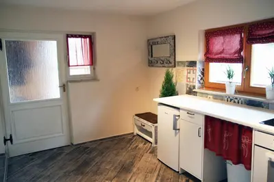 a kitchen with a white counter and a door at Apartma Obrh in Smarjeske Toplice