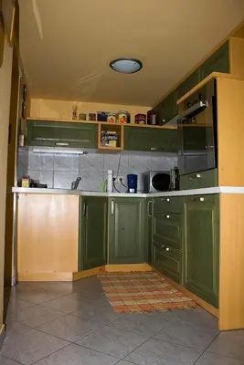a kitchen with green cabinets and a counter top at Apartma Obrh in Smarjeske Toplice
