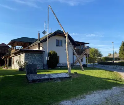 a house with a tree in front of it at Apartma Obrh in Smarjeske Toplice