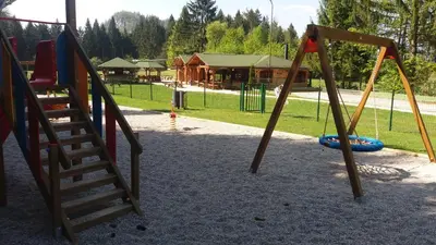 a playground with two swings and a ladder at Apartma Gracner in Bled