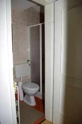 a bathroom with a toilet and a door open at Apartment Zupan in Maribor