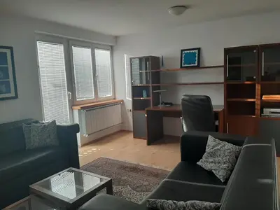 a living room with a couch and a desk at Apartment Zupan in Maribor