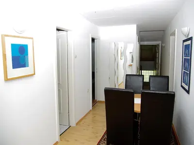 a dining room with a table and black chairs at Apartment Zupan in Maribor