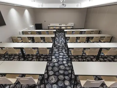 an empty classroom with rows of desks and chairs at Hotel Center Novo Mesto in Novo Mesto