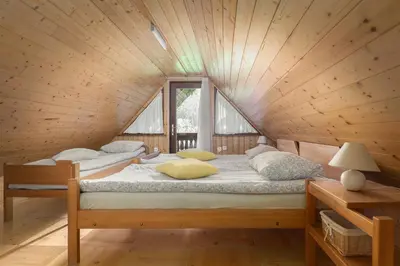 a bedroom with two beds in a wooden cabin at Holiday Homes Sara in Bled