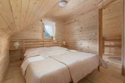 a bedroom with a bed in a log cabin at Holiday Homes Sara in Bled