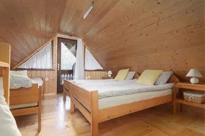 a bedroom with a bed in a wooden cabin at Holiday Homes Sara in Bled