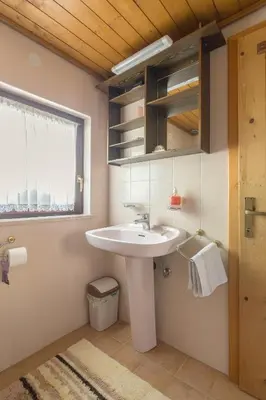a bathroom with a white sink and a window at Holiday Homes Sara in Bled