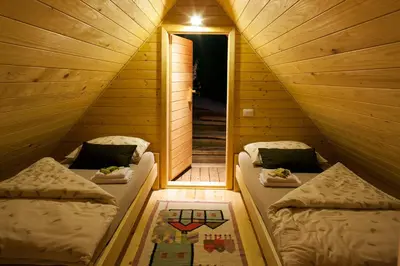 a small room with two beds and a window at Glamping Savinja in Ljubno