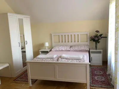 a bedroom with a white bed with two pillows at Apartments Maria in Ljubljana