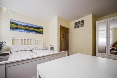 a bedroom with a bed and a table at Apartments Maria in Ljubljana