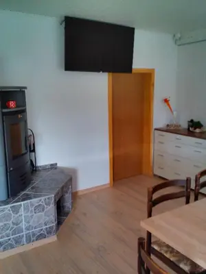 a living room with a flat screen tv on the wall at Apartment Janja in Vojnik