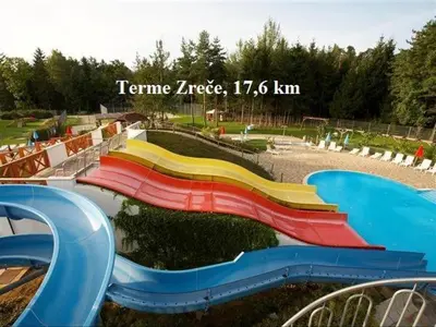 a playground with a colorful slide in a park at Apartment Janja in Vojnik