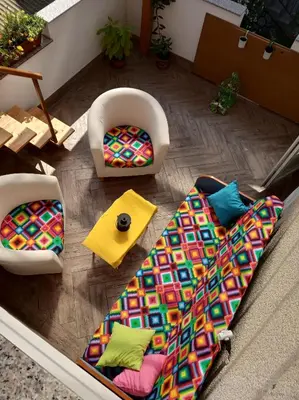 a living room with two chairs and a colorful couch at Apartment Janja in Vojnik