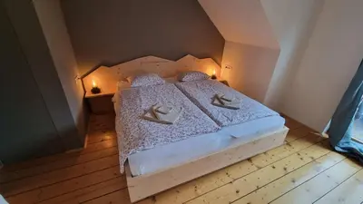 a bedroom with a bed with two pillows on it at Vila Koman Jezersko in Zgornje Jezersko
