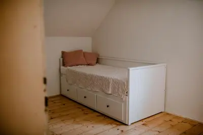 a small bedroom with a bed in the corner at Vila Koman Jezersko in Zgornje Jezersko