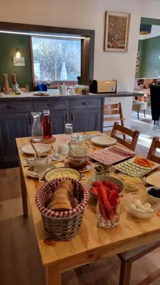 a wooden table with food on top of it at Vila Koman Jezersko in Zgornje Jezersko