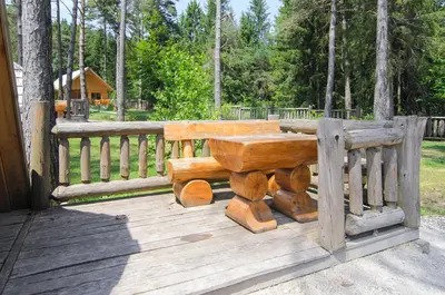 a wooden bench sitting on top of a wooden deck at Glamping Lake Bloke in Nova Vas