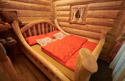 a bed in a log cabin in a room at Glamping Lake Bloke in Nova Vas