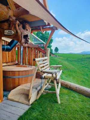 a chair sitting on the porch of a cabin at Glamping Lake Bloke in Nova Vas