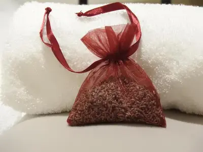 a red bag sitting on top of a pile of towels at Karst Stone Cottage in Štanjel